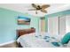 Bedroom with mounted television and coastal decor featuring light blue walls at 3122 Lake Valencia E Ln, Palm Harbor, FL 34684
