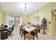 Cozy dining area with a chandelier and natural light, perfect for Gathering meals at 3122 Lake Valencia E Ln, Palm Harbor, FL 34684