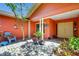 Inviting front porch with colorful walls, plants, chairs and double doors leading to the main entrance at 3122 Lake Valencia E Ln, Palm Harbor, FL 34684