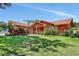 Charming single-story home with colorful landscaping and a well-maintained lawn at 3122 Lake Valencia E Ln, Palm Harbor, FL 34684