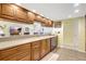 Kitchen with stainless steel appliances and wood cabinetry, offering a functional and stylish space at 3122 Lake Valencia E Ln, Palm Harbor, FL 34684