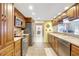 Spacious kitchen featuring stainless steel appliances, granite countertops, and tile floors at 3122 Lake Valencia E Ln, Palm Harbor, FL 34684