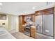 Well-lit kitchen with stainless steel appliances and dark wood cabinetry at 3122 Lake Valencia E Ln, Palm Harbor, FL 34684