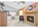 Cozy living room with a fireplace, built-in shelving, and tile flooring at 3122 Lake Valencia E Ln, Palm Harbor, FL 34684
