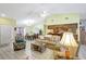 Open-concept living area with tile flooring and a view of the kitchen at 3122 Lake Valencia E Ln, Palm Harbor, FL 34684