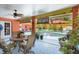 Outdoor patio view of the pool featuring plants, patio furniture, and a fan at 3122 Lake Valencia E Ln, Palm Harbor, FL 34684
