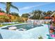 Private backyard pool surrounded by lush greenery and a relaxing patio area at 3122 Lake Valencia E Ln, Palm Harbor, FL 34684