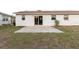 The house backyard features a concrete patio, a manicured lawn, and convenient outdoor space at 3139 Corona Dr, Holiday, FL 34690