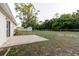 Spacious backyard featuring a concrete patio, grassy area, a shed, and partial fence at 3139 Corona Dr, Holiday, FL 34690