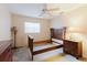 Spacious bedroom featuring a ceiling fan and a set of dark wood furniture at 3139 Corona Dr, Holiday, FL 34690