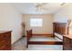 Spacious bedroom featuring a ceiling fan and a set of dark wood furniture at 3139 Corona Dr, Holiday, FL 34690