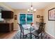 A dining area features a glass table, and backyard access with an adjacent, compact kitchen at 3139 Corona Dr, Holiday, FL 34690