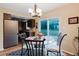 Eat-in kitchen with dining table, stainless steel refrigerator, and view of the backyard at 3139 Corona Dr, Holiday, FL 34690