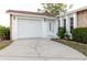 Home exterior displaying a garage, front door, and tidy landscaping alongside a driveway at 3139 Corona Dr, Holiday, FL 34690