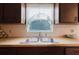 The kitchen features a stainless steel double sink and a window with blinds at 3139 Corona Dr, Holiday, FL 34690