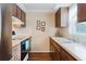 Functional kitchen with ample counter space, wood cabinetry, and view to backyard at 3139 Corona Dr, Holiday, FL 34690
