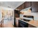 Kitchen showing updated appliances and view of the dining area with table and chairs at 3139 Corona Dr, Holiday, FL 34690