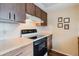 Well-organized kitchen with wood-look cabinets, electric stove, and neutral countertops at 3139 Corona Dr, Holiday, FL 34690