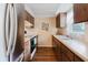 Efficient kitchen with wood cabinets, tile backsplash, and stainless steel refrigerator at 3139 Corona Dr, Holiday, FL 34690