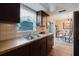 Bright kitchen with a stainless steel sink, updated countertops, and an adjacent dining area at 3139 Corona Dr, Holiday, FL 34690