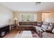 Inviting living room with a large sectional sofa, wood flooring, and ample natural light at 3139 Corona Dr, Holiday, FL 34690