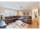 Spacious living room featuring a large sectional sofa, wood floors, and natural light from the window at 3139 Corona Dr, Holiday, FL 34690