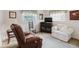 Cozy living room features a recliner, sofa, and decorative elements at 3139 Corona Dr, Holiday, FL 34690