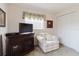 Living room featuring a TV, cabinet, and comfortable armchair near a window at 3139 Corona Dr, Holiday, FL 34690