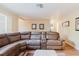 Comfortable living room featuring a sectional sofa, neutral walls, and hardwood floors, perfect for relaxation at 3139 Corona Dr, Holiday, FL 34690