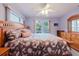 Main bedroom featuring a king-size bed, hardwood furniture, and ample natural light at 3139 Corona Dr, Holiday, FL 34690