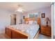Main bedroom featuring a decorative headboard, side tables, and adjacent closet at 3139 Corona Dr, Holiday, FL 34690