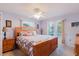 Spacious main bedroom with a ceiling fan, natural light, and hardwood furniture at 3139 Corona Dr, Holiday, FL 34690