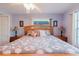 Well-lit main bedroom with a decorative headboard, side tables, and ceiling fan at 3139 Corona Dr, Holiday, FL 34690