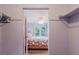 Spacious walk-in closet that offers a glimpse into the bright primary bedroom at 3139 Corona Dr, Holiday, FL 34690