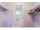 Walk-in closet leads to a pristine, all-white bathroom with natural light at 3139 Corona Dr, Holiday, FL 34690
