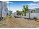 Backyard with fenced perimeter, gravel parking pad, and mature palm trees at 3300 Jackson N St, St Petersburg, FL 33704