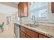 Sunlit kitchen featuring granite countertops, stainless steel sink, and ample cabinetry at 3300 Jackson N St, St Petersburg, FL 33704