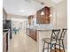 Well-lit kitchen featuring granite countertops, dark wood cabinetry, and bar seating at 3300 Jackson N St, St Petersburg, FL 33704