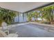 Outdoor patio with white chairs, palm trees and access to a spacious, fenced backyard at 3300 Jackson N St, St Petersburg, FL 33704