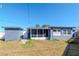 View of backyard, screened porch, a small shed, and the exterior of the house at 3445 Briar Cliff Dr, Holiday, FL 34691