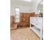 Bathroom features a white vanity, round mirror, and tiled shower with seat at 3445 Briar Cliff Dr, Holiday, FL 34691