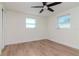 Light and airy bedroom with wood laminate flooring and ceiling fan at 3445 Briar Cliff Dr, Holiday, FL 34691