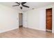 Bedroom includes ceiling fan, wood laminate flooring, closet and view to the hall at 3445 Briar Cliff Dr, Holiday, FL 34691