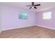 The bedroom features updated floors, ceiling fan and two windows for natural light at 3445 Briar Cliff Dr, Holiday, FL 34691