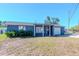 Charming single-story home with blue siding, front porch, and an attached one car garage at 3445 Briar Cliff Dr, Holiday, FL 34691