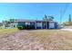 Charming single-story home with blue siding, front porch, and an attached one car garage at 3445 Briar Cliff Dr, Holiday, FL 34691