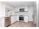 Charming kitchen with stainless steel appliances and white cabinets and updated countertops at 3445 Briar Cliff Dr, Holiday, FL 34691