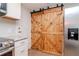 Modern kitchen details including stainless steel appliances and sliding barn door at 3445 Briar Cliff Dr, Holiday, FL 34691