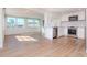 Bright kitchen features stainless steel appliances, white cabinets, and wood flooring at 3445 Briar Cliff Dr, Holiday, FL 34691
