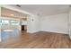 Bright and open living room with wood-look flooring flowing into the kitchen at 3445 Briar Cliff Dr, Holiday, FL 34691